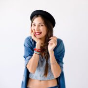 Portrait of smiling showing teeth young woman with hat Pijat Palembang 24 Jam