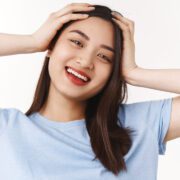 What beautiful lucky day. Optimistic carefree pretty asian brunette girl having wonderful summer holiday have fun touch head carefree extremely positive overjoyed mood smiling camera Deep Tissue Massage Jakarta